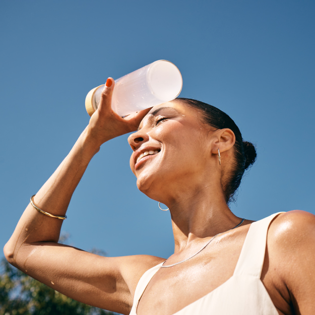 women outside using water bottle to cool her down